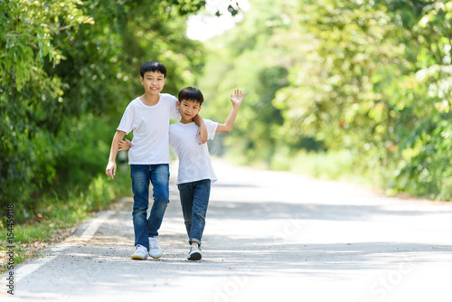 Two boy run in the park