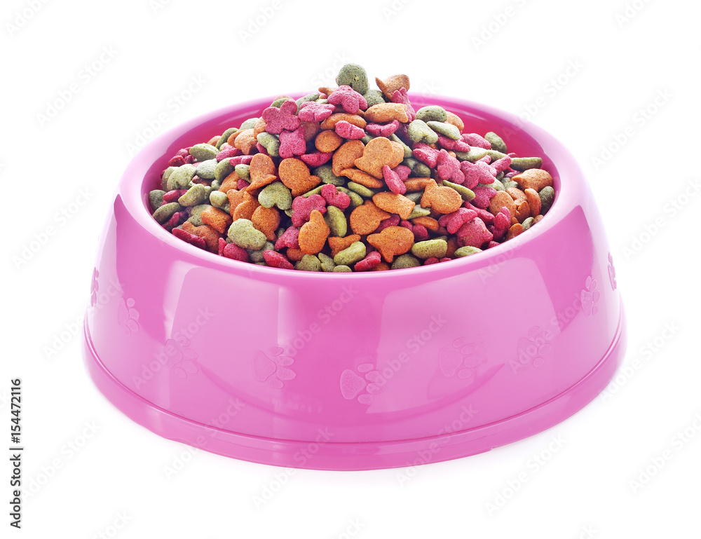 dry dog food in pink bowl isolated on white dry dog food in pink bowl isolated on white