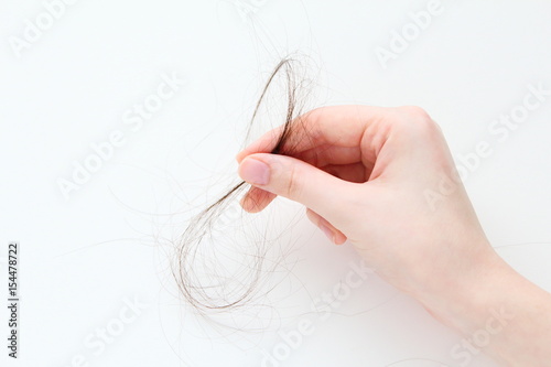 Female hand holding long hair