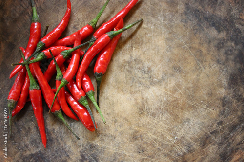 Hot and spicy red chilli on wood background