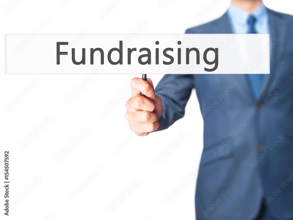 Fundraising - Businessman hand holding sign Fundraising - Businessman hand holding sign