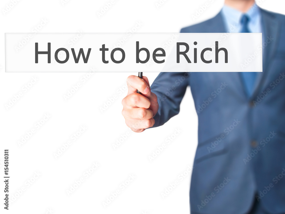 How to be Rich - Businessman hand holding sign How to be Rich - Businessman hand holding sign