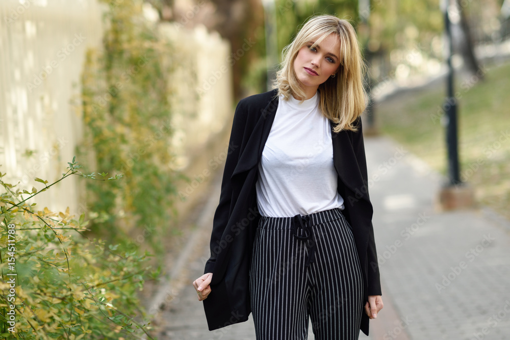 Beautiful young blonde woman in urban background Beautiful young blonde woman in urban background