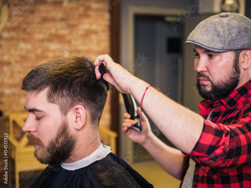 Adult male barber and customer in shop