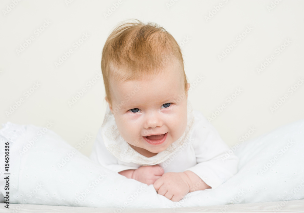 Smiling baby girl lying on her stomach