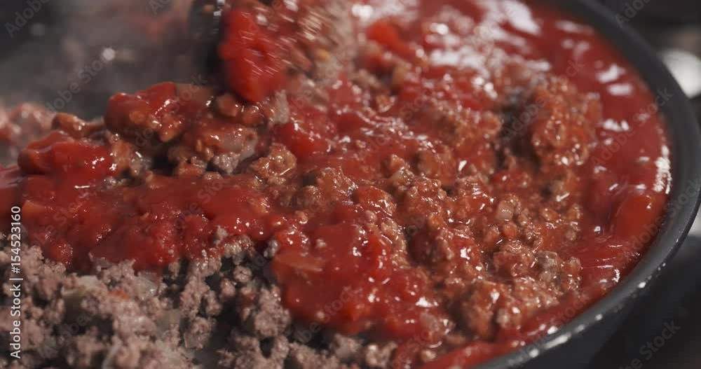 Slide shot of mixing tomato paste with roasting minced beef in a pan, 4k 60fps prores footage Slide shot of mixing tomato paste with roasting minced beef in a pan, 4k 60fps prores footage