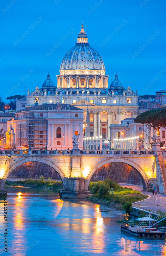 Evening view at the Angelo bridge and St. Peter's Basilica in Rome, Italy