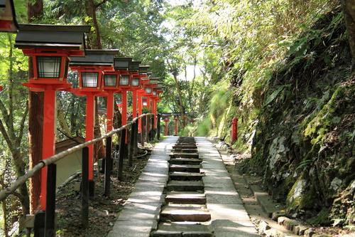 Red lanterns and stone steps at Kurama temple in Kyoto, Japan photo