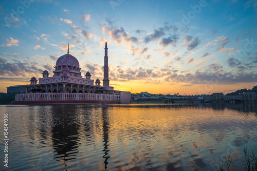 PUTRAJAYA, MALAYSIA - 9TH APRIL 2017; Sunrise moment at Putra Mosque, a principal mosque of Putrajaya, Malaysia. Construction of the mosque began in 1997 and was completed two years later.