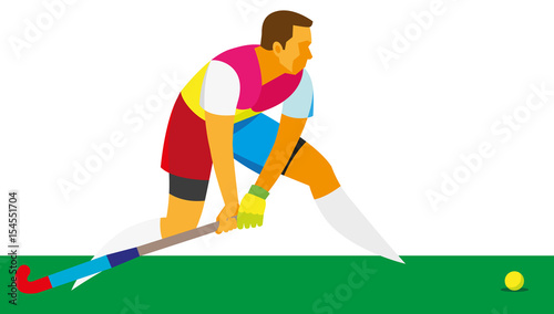 young man player in field hockey is preparing to hit the ball