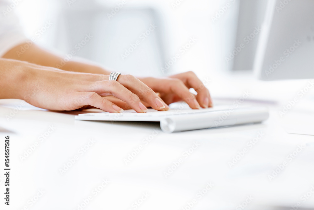 Female hands typing on the keyboard