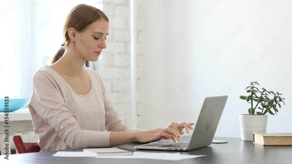 Young Creative Woman Working On Laptop in Office Young Creative Woman Working On Laptop in Office