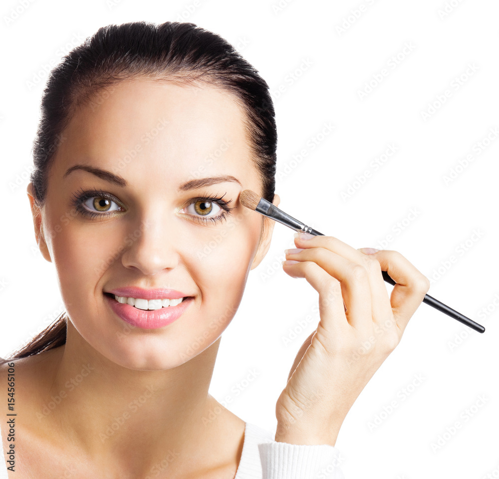 Smiling woman applying eye shadow, by visage brush, isolated