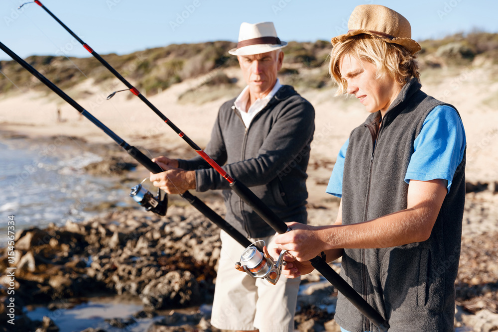 Senior man fishing with his grandson Senior man fishing with his grandson