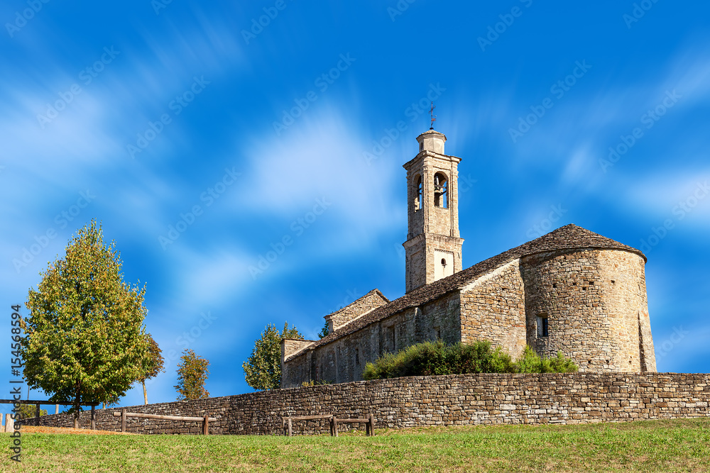 Old stone church under blue sky.