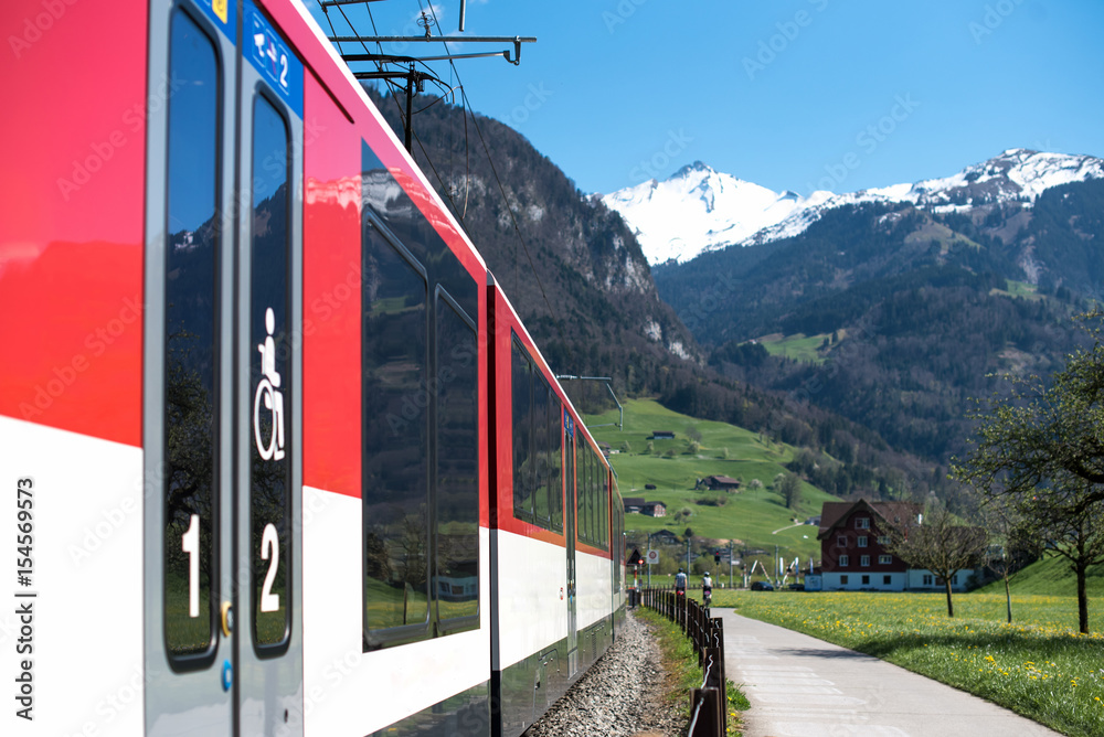 Red train and hills. Swiss Alps 