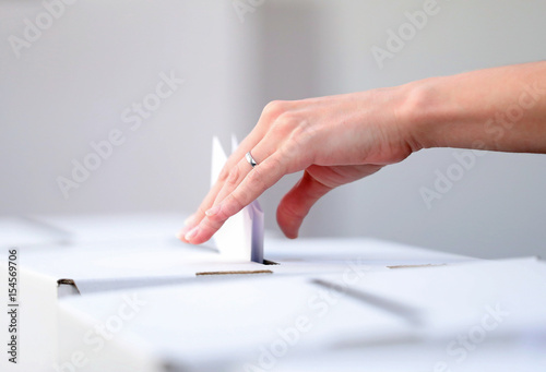 Woman casts her ballot at elections photo