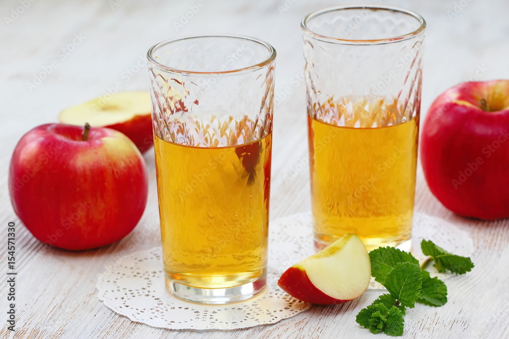 Apple juice and apples on the table