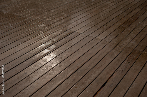 Texture of a wooden wet floor in the rain