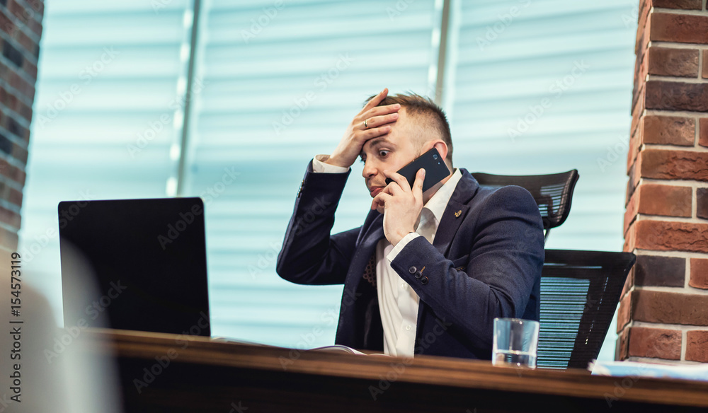 A businessman talking on a mobile phone,Businessman talking on the phone in office,Senior businessman,Portrait of businessman talking on mobile phone,business concept A businessman talking on a mobile phone,Businessman talking on the phone in office,Senior businessman,Portrait of businessman talking on mobile phone,business concept