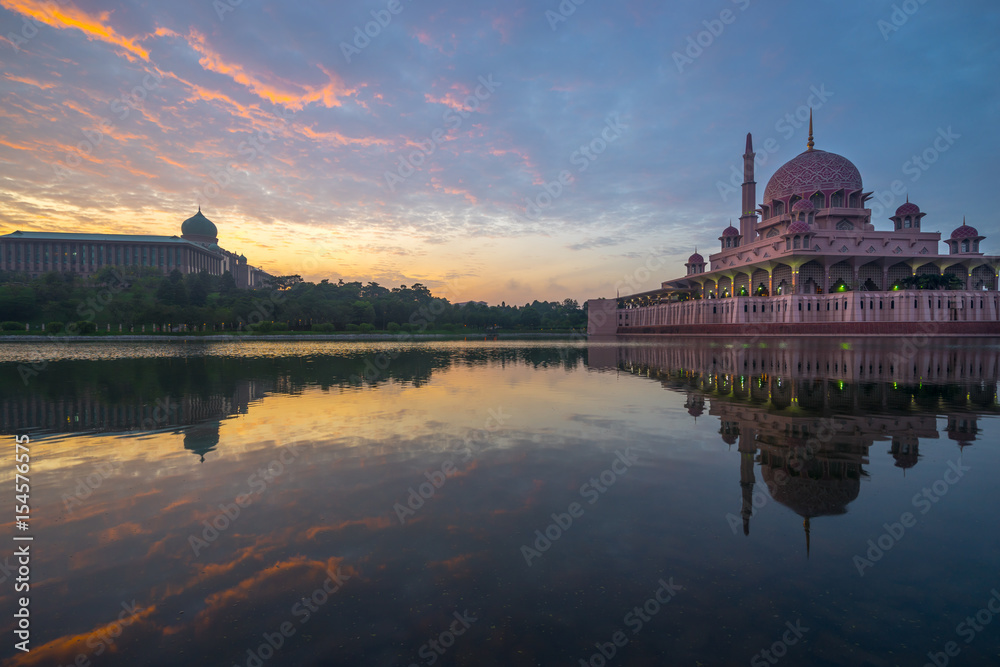 PUTRAJAYA, MALAYSIA - 16TH APRIL 2017; Sunrise moment at Putra Mosque, a principal mosque of Putrajaya, Malaysia. Construction of the mosque began in 1997 and was completed two years later.