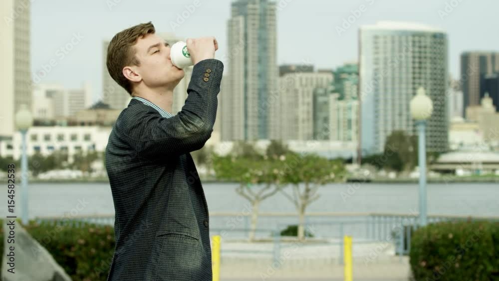 Handsome is drinking coffee on a sidewalk in Coronado Handsome is drinking coffee on a sidewalk in Coronado