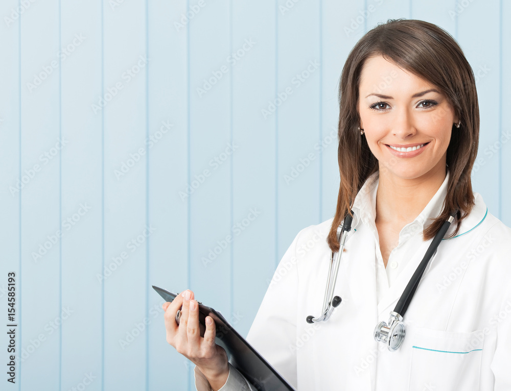 Smiling female doctor with clipboard at office Smiling female doctor with clipboard at office