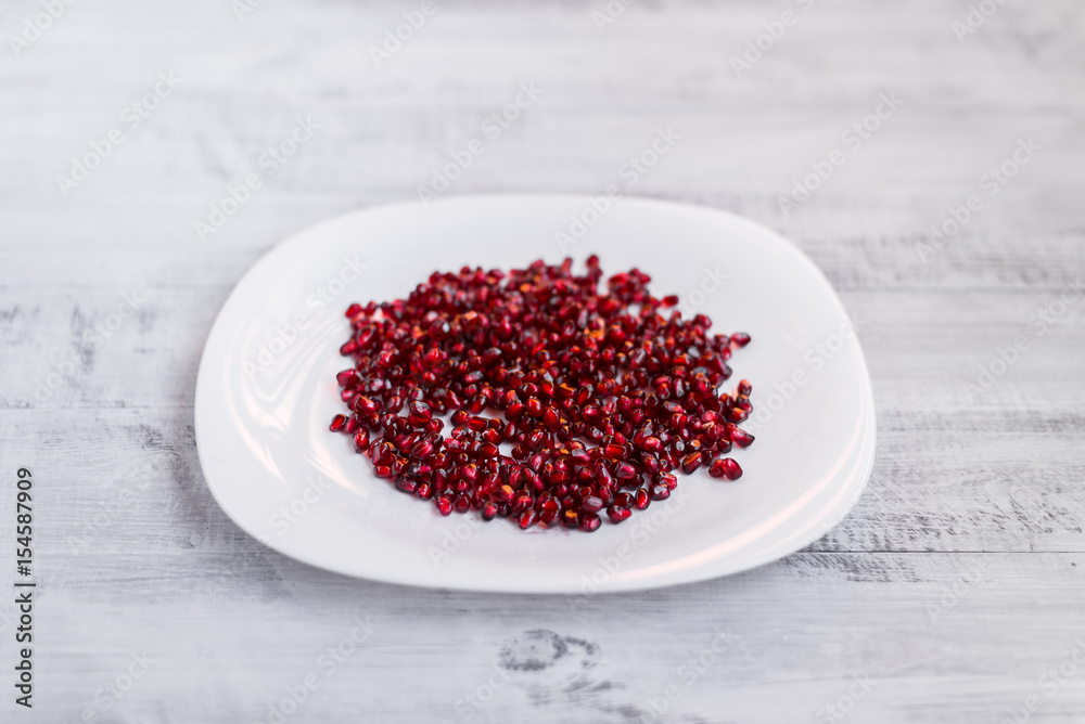 Garnet. Fresh pomegranate on an ecological table. Pomegranate seeds Garnet. Fresh pomegranate on an ecological table. Pomegranate seeds
