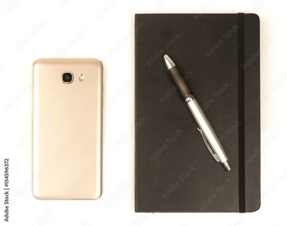 Back of cell phone with black notebook and pen Back of cell phone with black notebook and pen