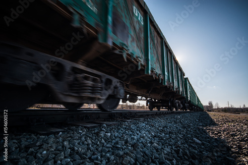 Freight train passing by. Nature landscape. Blurry / fast moving.