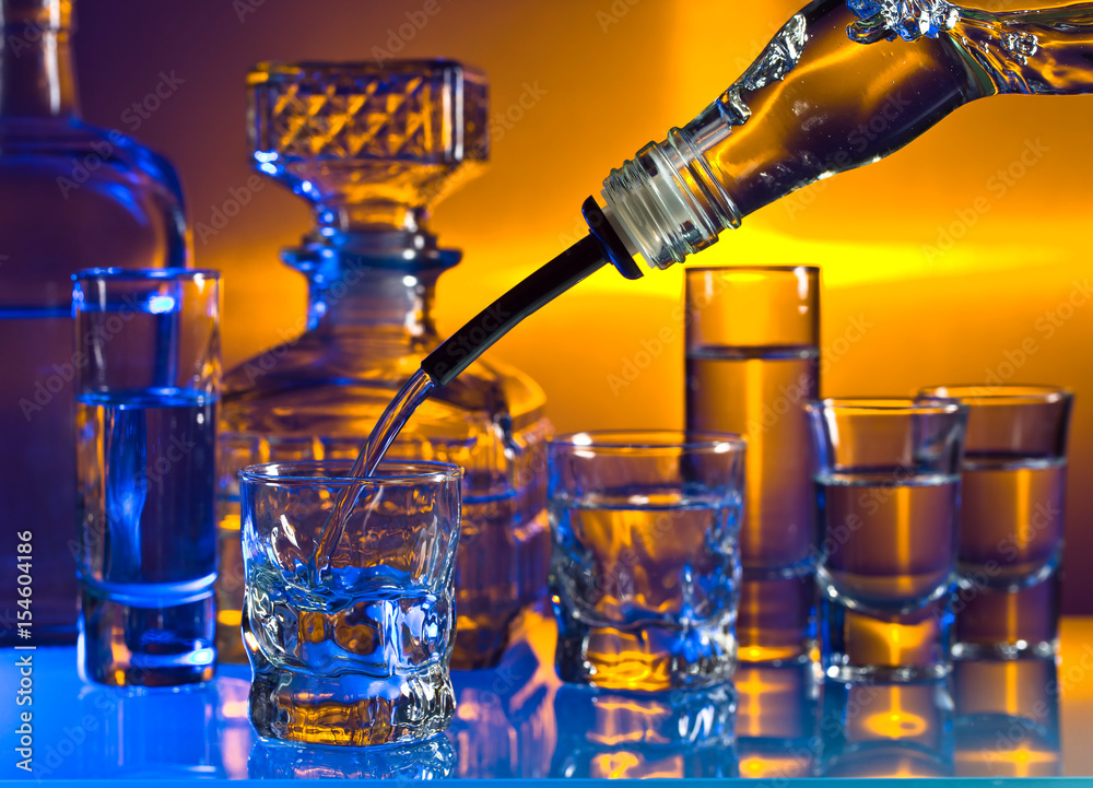 Glasses with alcoholic drinks on a glass table in bar Glasses with alcoholic drinks on a glass table in bar