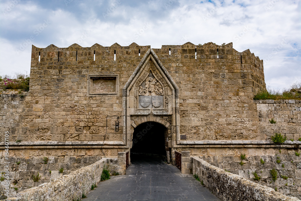 Gate of Saint John, bridge leading to it and moat at Rhodes old town, Greece