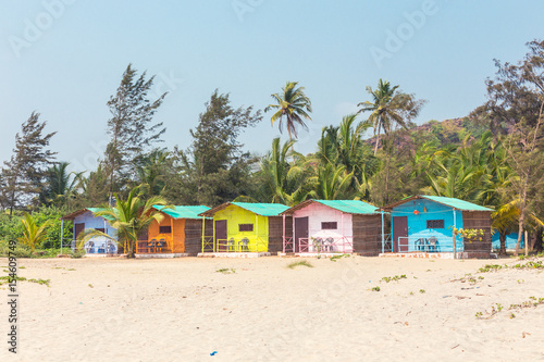 Palolym beach, colorful bungalows on the sea on the background of coconut palms, Goa, India. © Mariiam