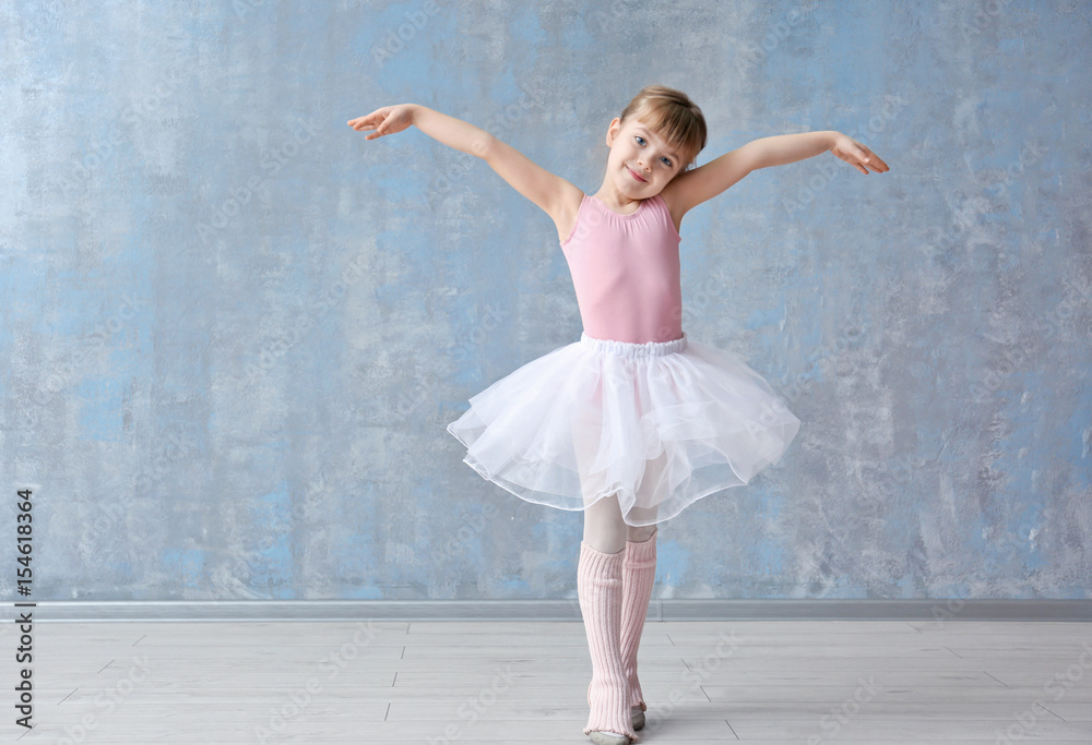 Obraz premium Cute little ballerina in dance studio