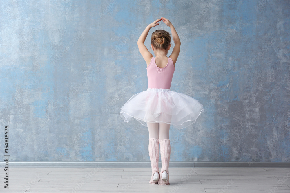 Naklejka premium Cute little ballerina in dance studio