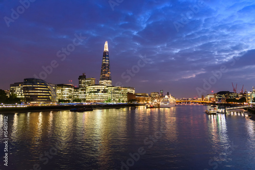 London city skyline and River Thames, UK, in the dusk evening