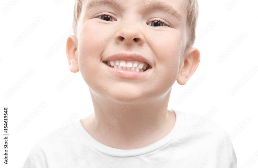Cute little boy showing teeth on white background, close up Cute little boy showing teeth on white background, close up