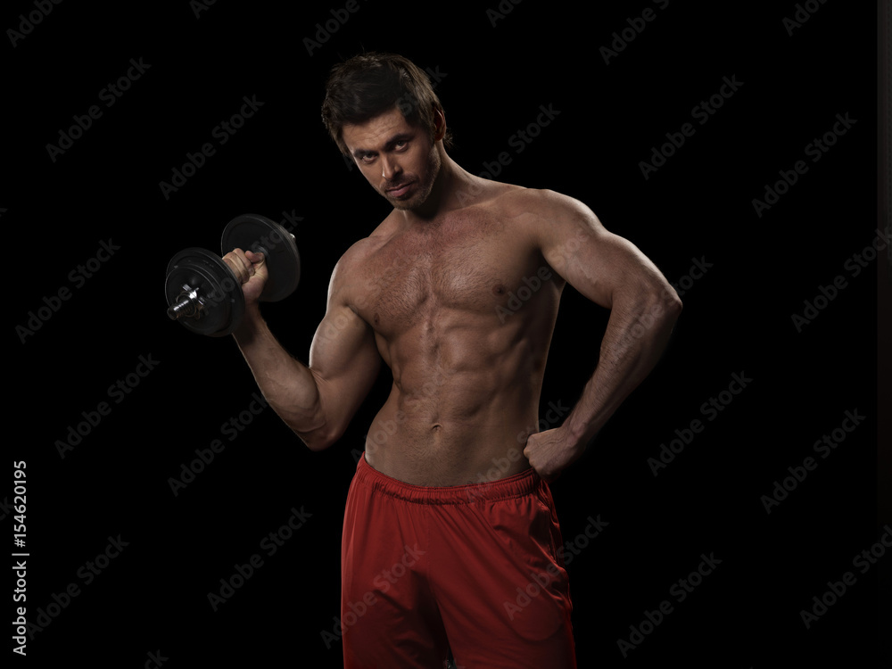 Man with bare chest lifting dumbbell