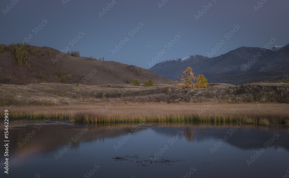 Mountain lake on a background of autumn landscape and snow capped mountains Mountain lake on a background of autumn landscape and snow capped mountains