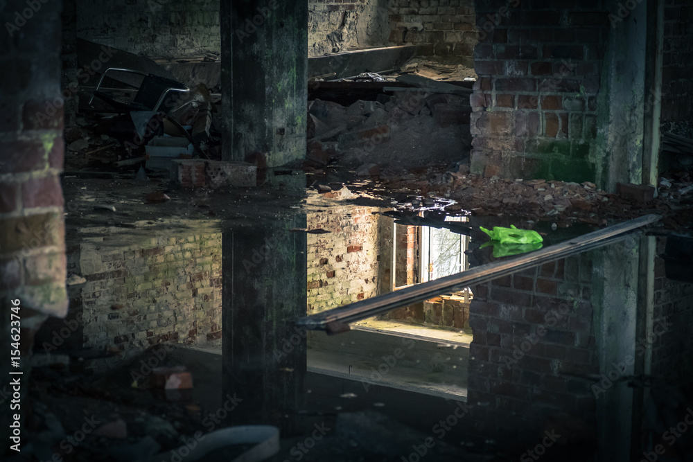 The view from an old, abandoned factory in inside with nice reflection and window light