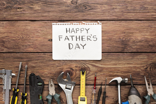 Happy Fathers Day background, card on rustic wood with repair tools