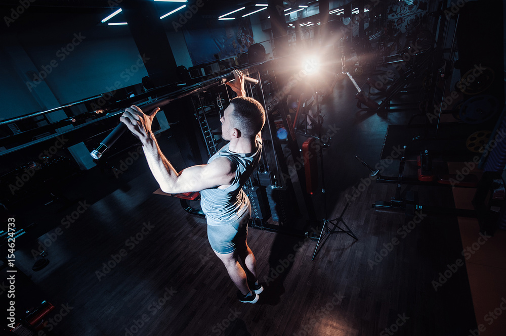 Athlete Muscular Fitness Male Model Pulling Up On Horizontal Bar In A Gym Stock Photo Adobe Stock