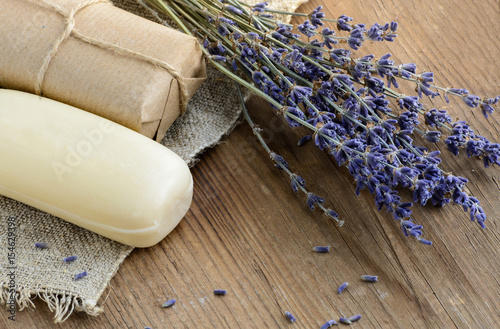 Dried lavender flowers with a soap on a rustic background