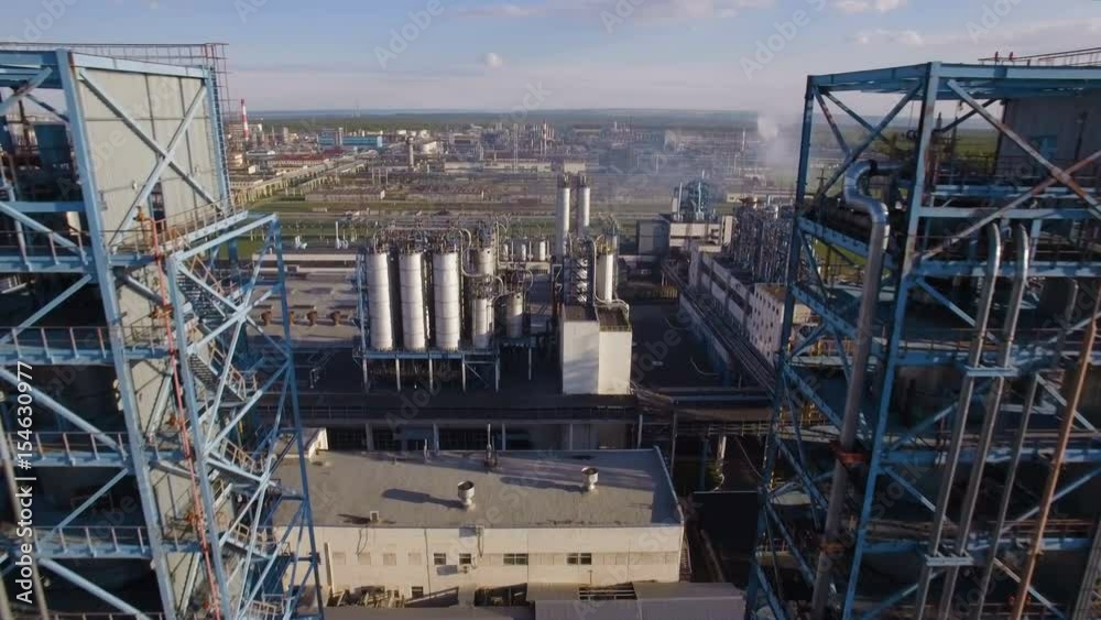 Two large distillation tower at the refinery on the backdrop of the industrial landscape. Aerial view Two large distillation tower at the refinery on the backdrop of the industrial landscape. Aerial view