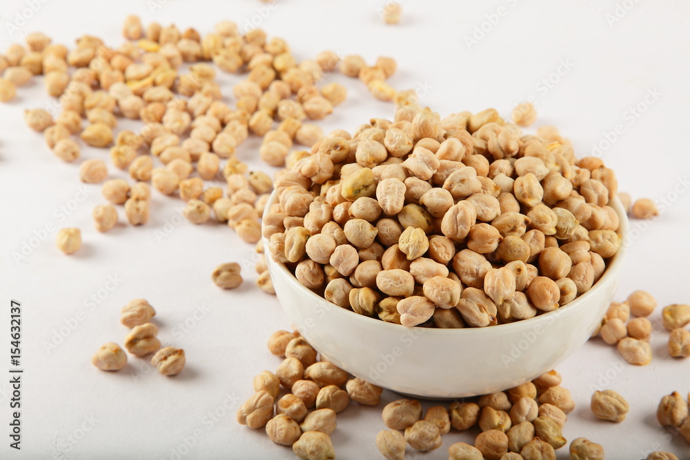 Uncooked chickpeas in white bowl. Uncooked chickpeas in white bowl.