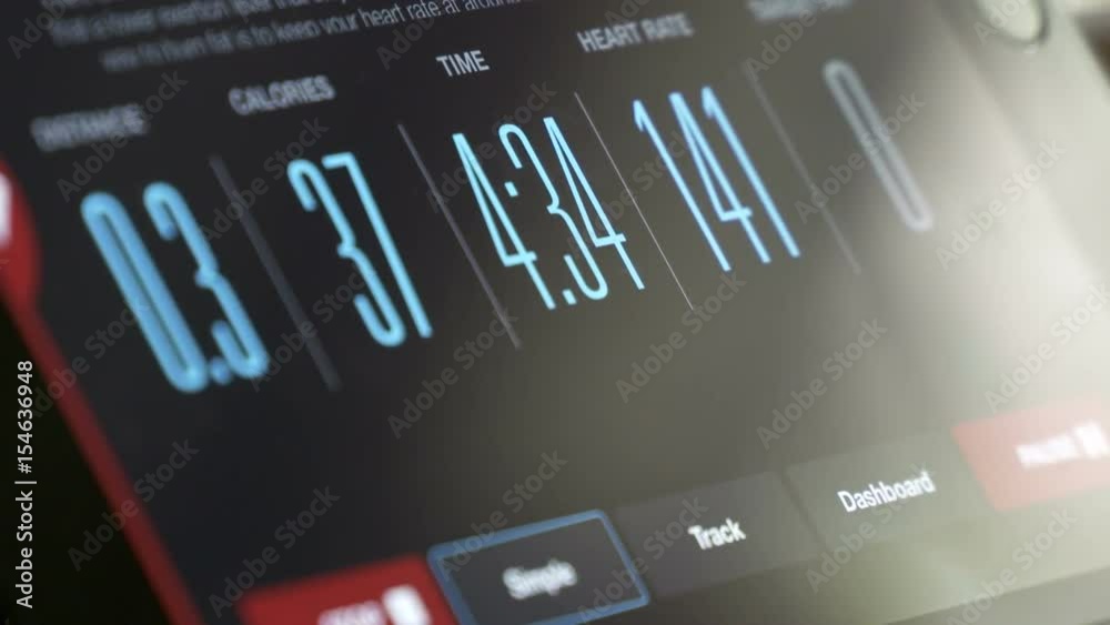 Fitness App displaying workout data on tablet screen time-lapse. Digital tablet linked with fitness machine displaying distance, burning calories, time and heart rate.
