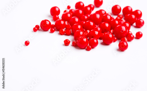Red beads on white background free space