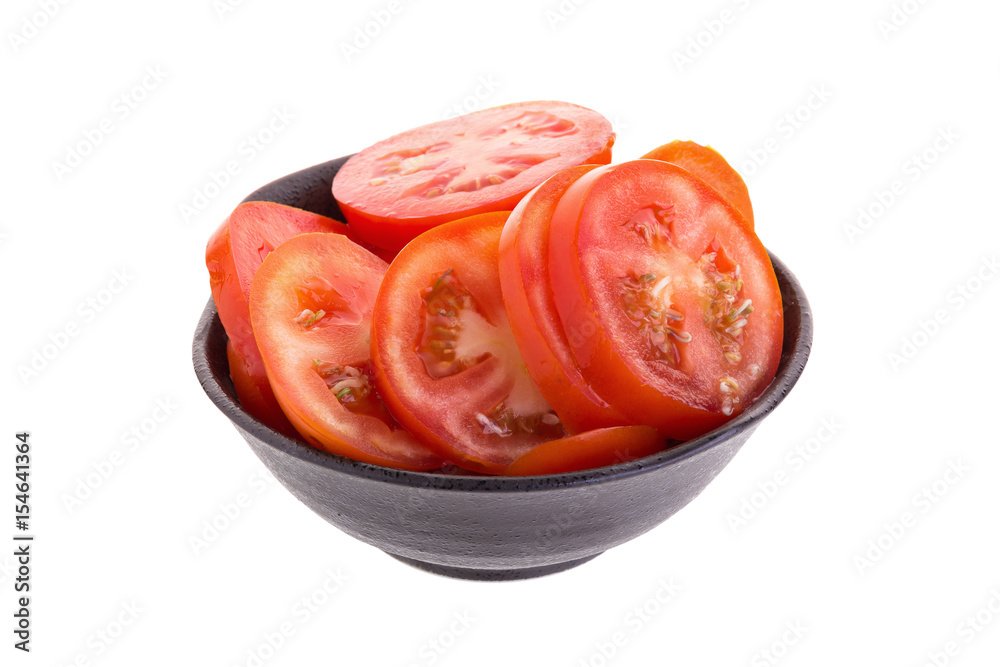 Slices of tomatoes in bowl isolated on white background Slices of tomatoes in bowl isolated on white background