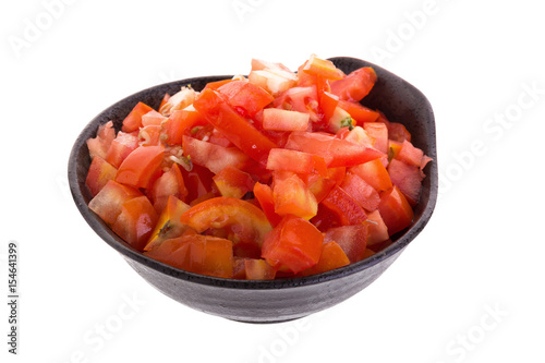 Chopped tomatoes in bowl isolated on white background