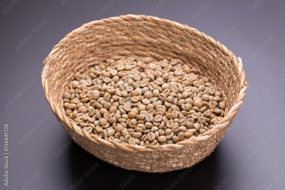 Unroasted coffee bean In the basket on black background Unroasted coffee bean In the basket on black background